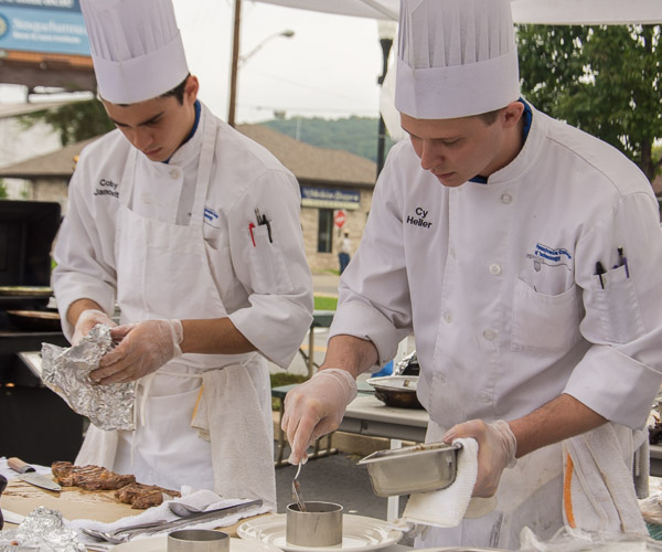 The first-place duo: R. Colby Janowitz, of Westminster, Md., and Cy C. Heller, of Milton. Heller adds potato hash to a mold that helps to form a tidy base layer for their entrée.