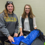 Students Ashley M. Otto and Kelsey L. Maneval pack Penn College backpacks that they’ll leave behind for residents of Nueva Santa Rosa, Guatemala.