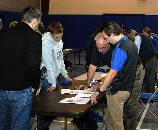 Tom Gregory, associate vice president for instruction, incorporates the college's hands-on approach during check-in.