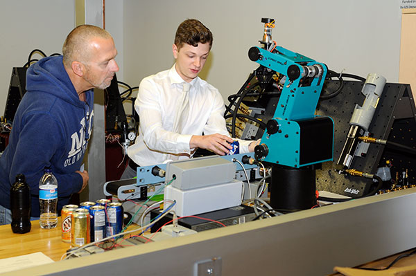 Zachary R. Althouse, of Womelsdorf, an electronics and computer engineering technology: robotics and automation emphasis major, demonstrates his 