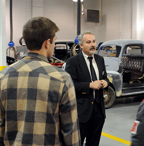 In the car-spangled space of College Avenue Labs, Roy H. Klinger, instructor of collision repair, explains the amazing opportunities available to automotive restoration technology students.