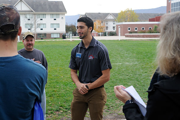 Resident Assistant Michael A. Daniele talks with a tour group in Rose Street Commons.