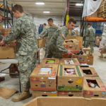 Cadet Austin S. Weinrich (center), a residential construction technology and management: building construction technology concentration student from Jenkintown, helps prove the adage, "Many hands make light work."