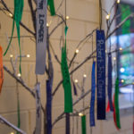 Ribbons, lights adorn tree of tribute.