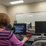 A visitor explores the college's information technology offerings.