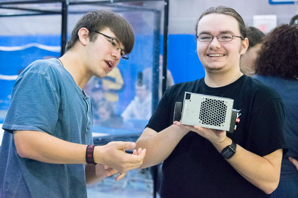 Damon K. Shoemaker (right), an electronics and computer engineering technology major from Easton, shows off 