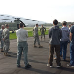 Students view helicopters and get an on-the-ground perspective from military personnel.