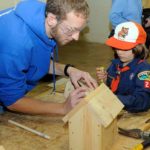 Helping a Cub Scout get the job done is Alexander J. Kosylo, of Pittsburgh, enrolled in residential construction technology and management: building construction technology concentration.