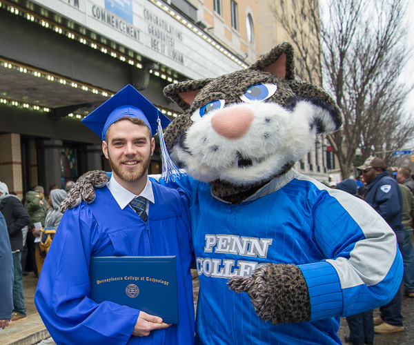 Striking a pose post-ceremony is Garrett L. Woodring, Tyrone, heating, ventilation and air conditioning technology, and our favorite mascot. 
