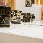 Mugs created by Penn College art faculty await silent bidders. 