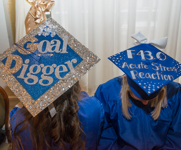 Sparkling grad caps recognize goals and a diagnosis code familiar to health information technology majors.