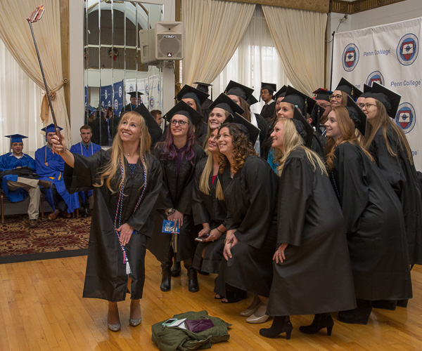Armed with a selfie stick and smile, Alicia A. Brant, a nursing graduate from Mifflinburg, gathers a glorious group. 