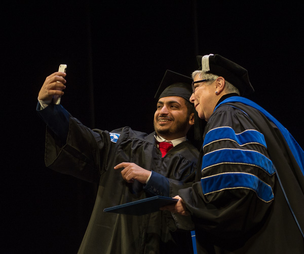 Selfies with the president are still in style! An international student makes a memory. 