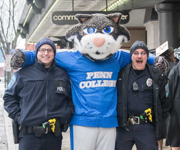 Penn College Police Officers Justin M. Hakes (left) and Charles E. O'Brien share laughs with a furry buddy.