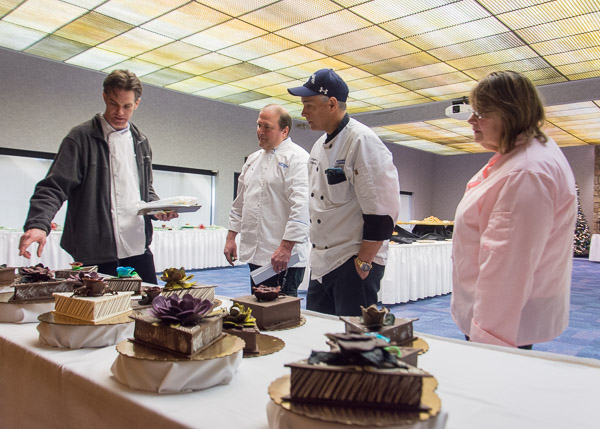 Chef Charles R. Niedermyer, instructor of baking and pastry arts/culinary arts, left, talks with judges about students’ chocolate boxes, which were exhibited but not judged. Judges, from left, are Robert E. Engle, part-time instructor and owner of Catherman’s Homemade Candy; Stephen A. Manley, executive chef of Le Jeune Chef; and Sue L. Mayer, owner of Grammy Sue’s Cakes and Cookies and a retired faculty member.