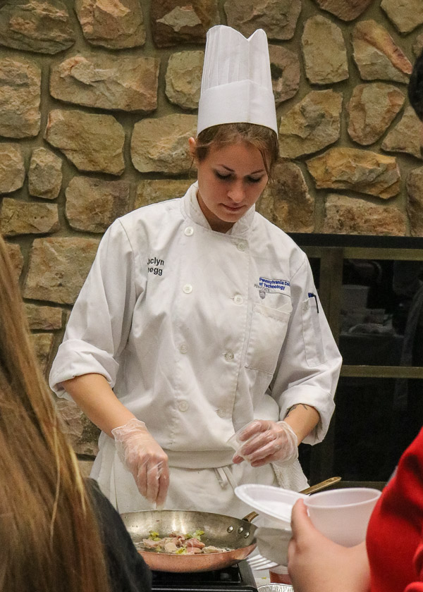 Jaclyn C. Gregg demonstrates an example of restaurant tableside cooking.