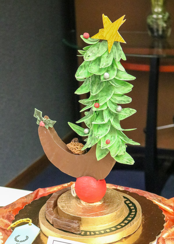 A tree teeters over a toy railroad in a chocolate sculpture by Paige E. Pearson. The piece received an honorable mention from judges.