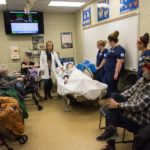 Samantha M. Weaver, learning laboratory coordinator for nursing education, shows the functions of SimMom, one of five high-fidelity mannequins that can be programmed to imitate real health conditions.