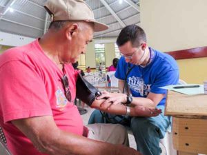 Penn College student H. Alex Simcox takes a patient’s blood pressure during a study abroad experience at a medical clinic in Nueva Santa Rosa, Guatemala. He was among five Penn College students making the trip.