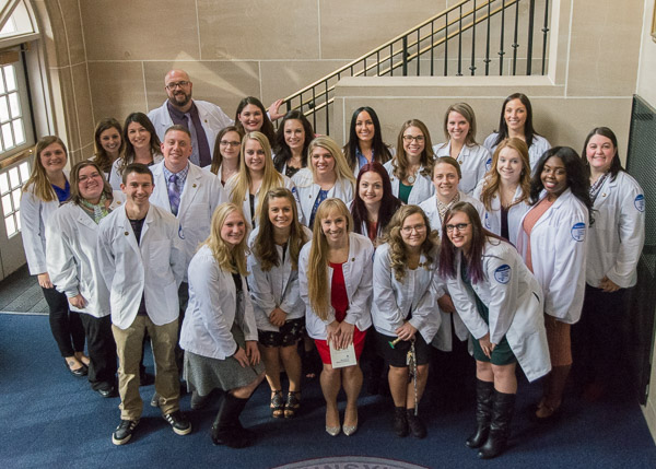 Bachelor-degree nursing grads gather after their pinning ceremony. 