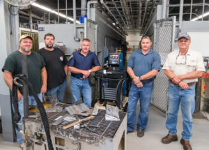 Representatives from Penn College’s welding department and Miller Electric Manufacturing Co. mark the company’s equipment loan to the program. From left are Matt W. Nolan, welding instructor; Michael C. Schelb, welding lecturer; Rick Conrad, field application engineer at Miller; Rick Scharenbroch, industrial district manager at Miller; and Timothy S. Turnbach, welding instructor.