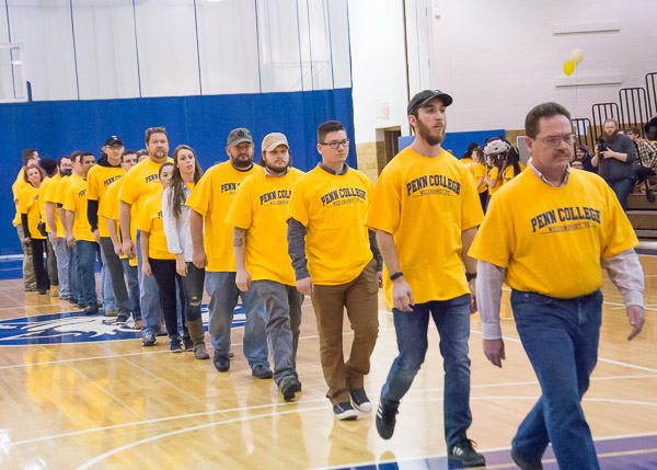 Twenty Penn College servicemen and women walk onto the court, representing the number of veterans lost to suicide every day.