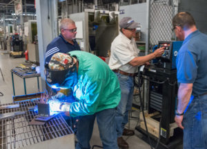 Miller Electric Manufacturing Co. representatives train welding faculty on new equipment entrusted to the lab.
