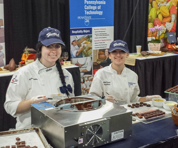 Keegan D. Sonney and Merissa N. Aucker prepare bonbons at the college’s booth at the Philadelphia National Candy, Gift and Gourmet Show.