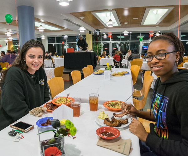Grabbing a bite and enjoying the night are Shaylin A. Stranges (left), a pre-dental hygiene student from Telford, and Jessica T Haynes, a culinary arts and systems major from Bethlehem.