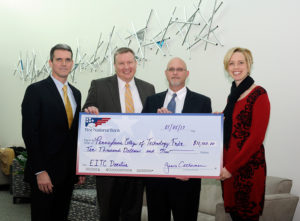 Representatives of First National Bank present a $10,000 gift that will support two innovative educational programs offered by Penn College for high school students. From left are FNB’s Don Breon, assistant vice president/treasury management; Dan Hooper, market manager/vice president; and Peter Bower, team leader/vice president; with Elizabeth A. Biddle, the college’s director of corporate relations.