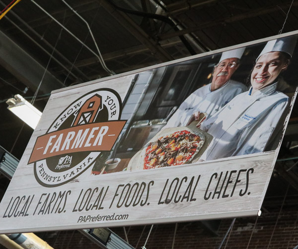 The value of Pennsylvania farm products to Pennsylvania restaurants (and patrons) was emphasized through giant banners – this one featuring Penn College’s Chef Michael J. Ditchfield and culinary arts technology student Tessa M. Stambaugh.