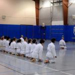 In formation behind Penn College coach George T. Vance Jr., martial artists prepare for a belt-promotion event last fall.