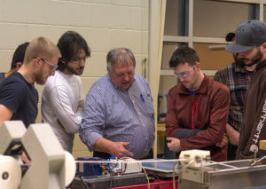 Penn College plastics students work in an extrusion lab under the direction of Gary E. McQuay, center, engineering manager for the Plastics Innovation Resource Center at the college. Sekisui SPI, part of Sekisui Chemical Co., is establishing a scholarship for first-year plastics students at Penn College.