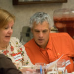 April R. and Stephen A. Manley, sporting name tags identifying them as Betty Boop and Christopher Walken, decipher clues at the table. (Stephen is the executive chef at the college's Le Jeune Chef Restaurant.)