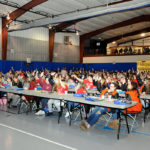 Students raise their hands to indicate their substantial presence on Facebook, Instagram, Snapchat and Twitter during a discussion of the permanence of online words and images.