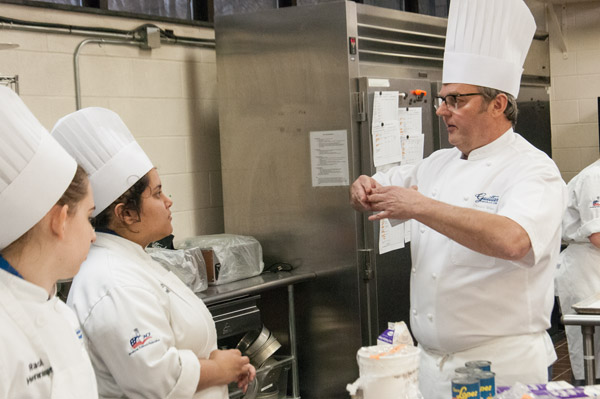 Wressell provides direction to baking and pastry arts students Rachel A. Henninger, of Bellefonte, and Natascha G. Santaella, of Guaynobo, Puerto Rico.