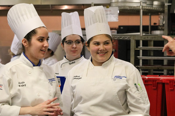 Baking and pastry arts students Kepley; Keegan D. Sonney, of Erie; and Andrea L. Solenberger, of Harrisburg, react to words from Wressell.