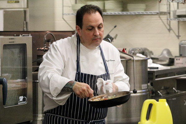 Tramonto, who climbed from high school dropout to award-winning celebrity chef by “outworking everyone” gets hands-on in the college’s hospitality labs.