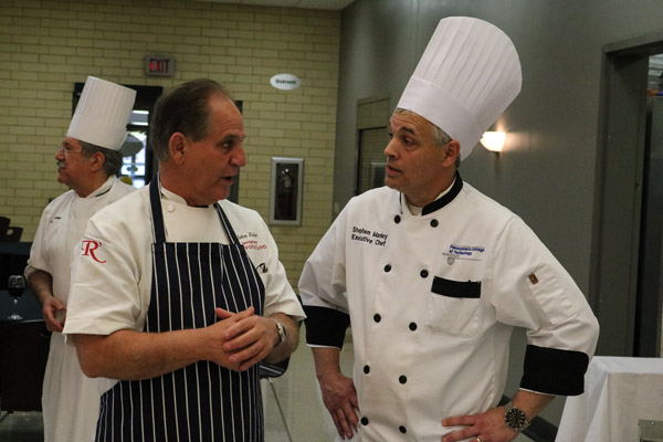 Folse talks with Penn College’s Chef Stephen A. Manley, executive chef of Le Jeune Chef Restaurant, just before guests arrive to a pre-dinner reception, where students helped to serve two of Folse’s Louisiana signatures: corn and lump crab bisque, and duck and andouille sausage gumbo.