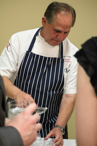Folse helps to serve his duck and andouille sausage gumbo, a traditional Louisiana dish he also served to Pope John Paul II.