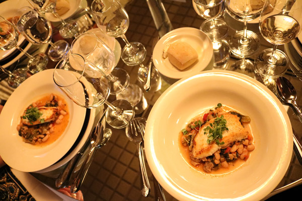 The fish course, “Osteria di Tramonto Halibut,” is surrounded by sparkle on the mirror-covered tables in Le Jeune Chef.