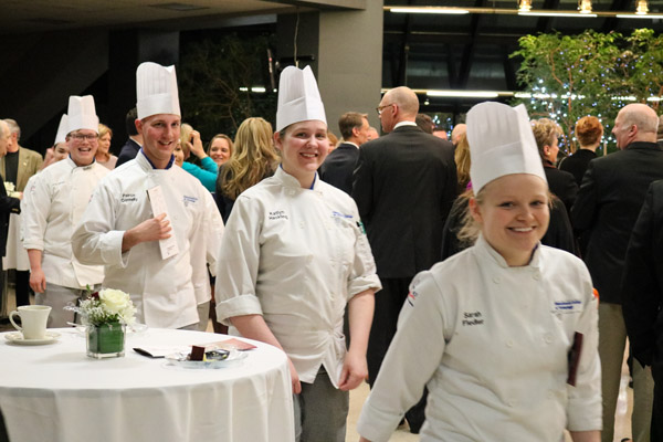 Fulfilling a Visiting Chef tradition, the students who helped to prepare the evening’s offerings are recognized with a procession through the dining room. From front are culinary arts and systems students Sarah B. Fiedler, of Lock Haven; Katlyn J. Hackling, of Williamsport; and Peirce A. Connelly, of Northumberland; and baking and pastry arts student Lloyd A. Shope, of Blanchard.