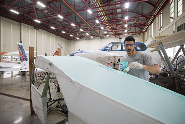 Andre J. Aldubayan, an aviation maintenance technology student from Old Forge, spends Open House day working on his senior project (and ready to answer aviation queries) in the hangar of the Lumley Aviation Center. 