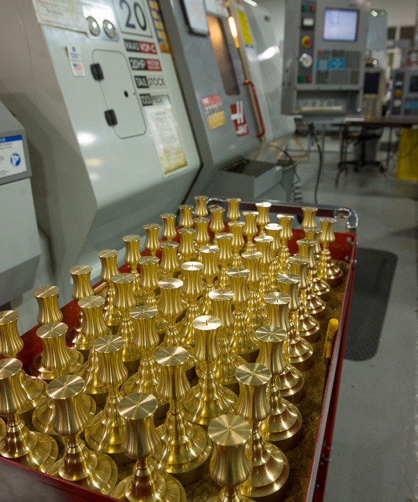 The glow of candlesticks (in progress) adds a dash of eye-pleasing artistry to the manufacturing lab.