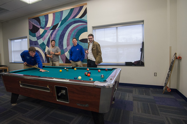 Between Residence Life tours, students enjoy a game in Dauphin Hall's first-floor lounge. 