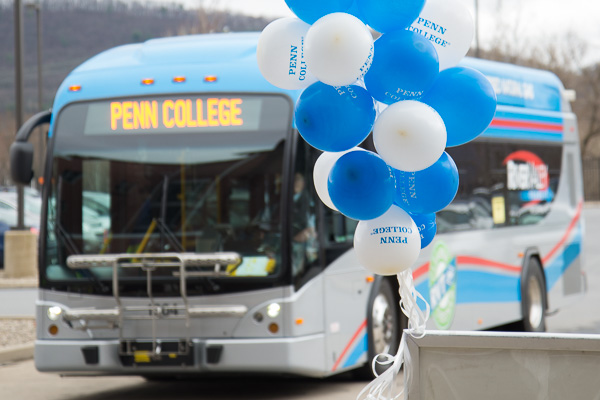 Welcome signs: balloons and a River Valley Transit shuttle bus. 