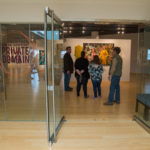 Gallery guests discuss the works of “Private Domain.”