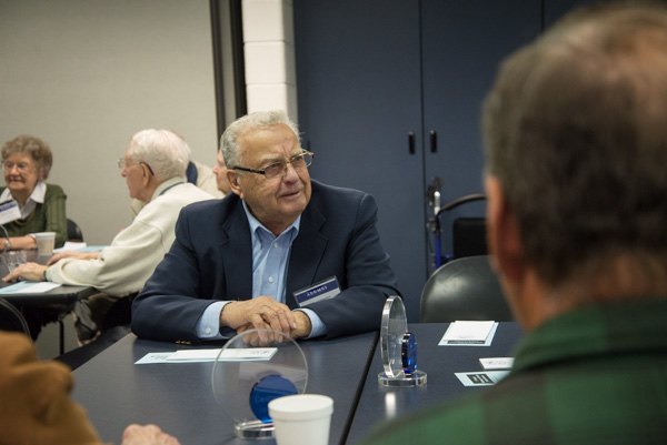 Edward Danneker, ’56, sheet metal, discusses days gone by and current news with former classmates. 