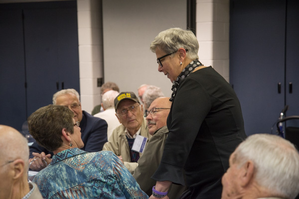 The president makes her way around the room. 
