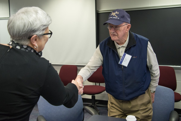 Raymond Eck, ’41, drafting, whose World War II valor was featured in the Spring 2017 issue of Penn College Magazine, shakes hands with the college president. 